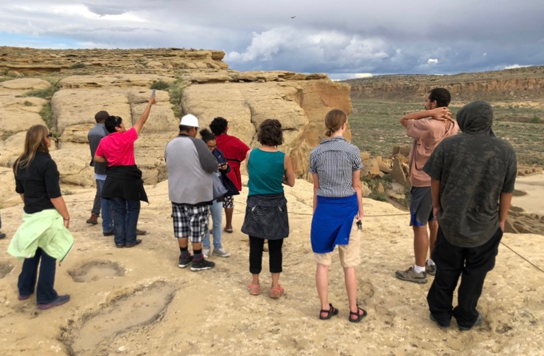 Group standing near edge of cliff on Navajo reservation