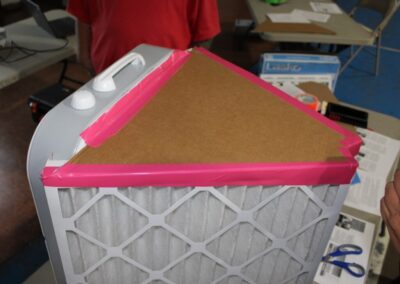DIY air filter with fan attached to cardboard and two air filters.