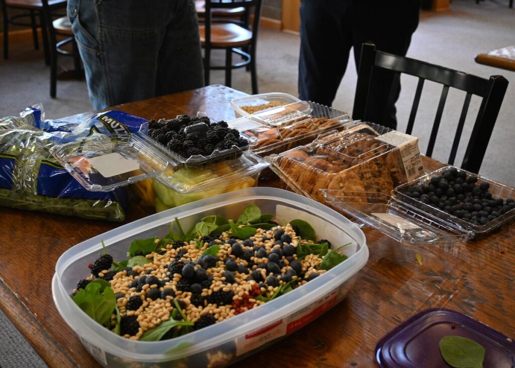 Staci Emm’s salad of spinach, pine nuts, buckberries, blueberries. In the background, some less traditional but still enjoyable treats (oatmeal cookies!) 
