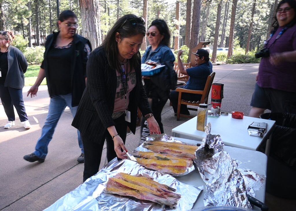 Vicki Hebb prepares Lahontan cutthroat trout fillets for the grill