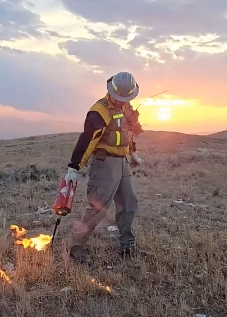 Noah Valdez lights a fire using a drip torch