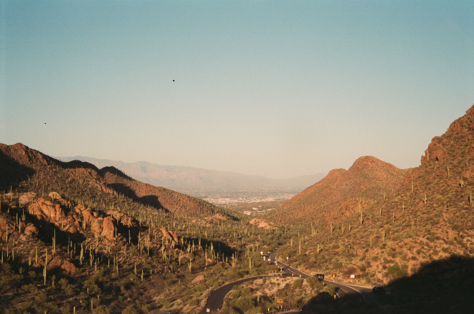 View of desert canyon with road cutting through mountain pass